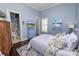 Serene bedroom with wood floors, ensuite bathroom and blue accents at 2961 Sanctuary Cir, Lakeland, FL 33803