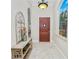 Bright entryway with tile flooring, decorative window, and wood door at 2961 Sanctuary Cir, Lakeland, FL 33803