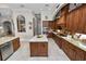 Open kitchen with granite countertops, custom cabinetry, and large island at 2961 Sanctuary Cir, Lakeland, FL 33803