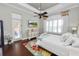 Bright main bedroom with a king bed, hardwood floors, and access to the patio at 2961 Sanctuary Cir, Lakeland, FL 33803