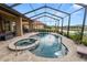 Resort-style pool and spa with covered patio at 2961 Sanctuary Cir, Lakeland, FL 33803