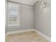 Bright bedroom with light walls, wood floors, and window with blinds at 306 Avenue C Ne, Winter Haven, FL 33881