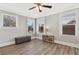 Bedroom with hardwood floors, ceiling fan and windows at 306 Avenue C Ne, Winter Haven, FL 33881