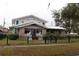 Two-story house with a metal roof, stone accents, and a fenced yard at 306 Avenue C Ne, Winter Haven, FL 33881