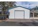 Detached garage with roll-up door and solar panel at 306 Avenue C Ne, Winter Haven, FL 33881