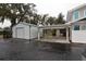 Property features a metal garage and covered parking at 306 Avenue C Ne, Winter Haven, FL 33881