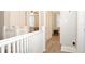 Upstairs hallway with white railing and wood-look floors at 306 Avenue C Ne, Winter Haven, FL 33881