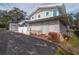 Exterior view of house with gray siding and landscaping at 306 Avenue C Ne, Winter Haven, FL 33881