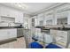 Modern kitchen with white shaker cabinets, stainless steel appliances and breakfast area at 306 Avenue C Ne, Winter Haven, FL 33881