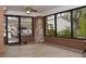 Sunroom with view of backyard and a stone accent wall at 306 Avenue C Ne, Winter Haven, FL 33881