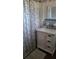 Bathroom with a white vanity and floral shower curtain at 308 Kerneywood St, Lakeland, FL 33803