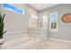 Relaxing bathroom featuring a soaking tub and walk-in shower at 3098 Pearly Dr, Lakeland, FL 33812