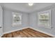 Simple bedroom with two windows and wood flooring at 3220 Clubhouse Rd, Lakeland, FL 33812