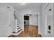 Bright entryway with stairs leading to the upper level, and view into living room at 3220 Clubhouse Rd, Lakeland, FL 33812