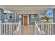 Inviting front porch with a ramp and white railings at 3220 Clubhouse Rd, Lakeland, FL 33812