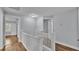 Upper hallway with white railings and doors to bedrooms at 3220 Clubhouse Rd, Lakeland, FL 33812