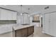 Modern kitchen with white cabinets, granite island, and stainless steel appliances at 3220 Clubhouse Rd, Lakeland, FL 33812