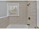 Updated shower with neutral tile and a window at 3220 Clubhouse Rd, Lakeland, FL 33812