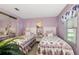 Guest bedroom with two twin beds and mirrored closet at 3221 Pebble Bend Dr, Lakeland, FL 33810