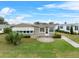 Tan single-story home with carport and landscaped lawn at 3221 Pebble Bend Dr, Lakeland, FL 33810