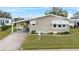 Tan single-story home with covered parking at 3221 Pebble Bend Dr, Lakeland, FL 33810