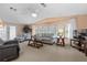 Living room with striped sofa, two armchairs, and large windows at 3221 Pebble Bend Dr, Lakeland, FL 33810