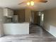 Open kitchen with white cabinets and an island at 3472 Avenue V Nw, Winter Haven, FL 33881