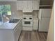 Efficient kitchen featuring white cabinets and modern appliances at 3472 Avenue V Nw, Winter Haven, FL 33881