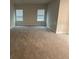 Open living area with neutral carpeting and large windows at 357 Siesta Vista Ct, Davenport, FL 33896