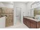 Main bathroom with walk-in shower, soaking tub, and granite vanity at 3604 Frentress Dr, Lakeland, FL 33812