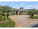 House exterior features a paver driveway, two palm trees, and a gray color scheme at 3604 Frentress Dr, Lakeland, FL 33812