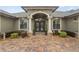 Front entrance with double doors, columns, and a paver walkway at 3604 Frentress Dr, Lakeland, FL 33812