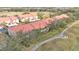 Aerial view showcasing townhouses near a golf course and walking path at 362 Enclave Dr, Lakeland, FL 33803