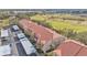 Aerial view of townhouses, covered parking, and a scenic golf course at 362 Enclave Dr, Lakeland, FL 33803