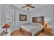 Cozy bedroom with wood-framed bed, window with blinds and wood floors at 362 Enclave Dr, Lakeland, FL 33803