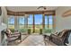 Sunroom with golf course view and wicker furniture at 362 Enclave Dr, Lakeland, FL 33803