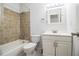 Updated bathroom with beige tile and a white vanity at 408 Patrick Ave, Winter Haven, FL 33880