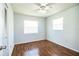 Bedroom with wood floors, ceiling fan and two windows at 408 Patrick Ave, Winter Haven, FL 33880