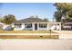 Renovated single story home featuring a gray door and black window accents at 408 Patrick Ave, Winter Haven, FL 33880