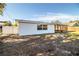 White house exterior with screened porch and grassy backyard at 408 Patrick Ave, Winter Haven, FL 33880