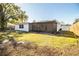 Back exterior of house showing screened porch and yard at 408 Patrick Ave, Winter Haven, FL 33880