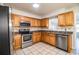 Kitchen with stainless steel appliances and wood cabinets at 408 Patrick Ave, Winter Haven, FL 33880