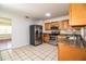 Updated kitchen features stainless steel appliances and wood cabinets at 408 Patrick Ave, Winter Haven, FL 33880