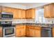 Kitchen with stainless steel appliances and wood cabinets at 408 Patrick Ave, Winter Haven, FL 33880