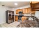 Kitchen with stainless steel appliances and wood cabinets at 408 Patrick Ave, Winter Haven, FL 33880