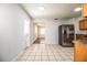 Bright kitchen with stainless steel refrigerator and view into adjacent living area at 408 Patrick Ave, Winter Haven, FL 33880