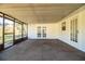 Spacious screened porch with concrete flooring and double doors at 408 Patrick Ave, Winter Haven, FL 33880