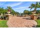 Brick courtyard with a water fountain and tropical plants at 4108 Solamor St, Lakeland, FL 33810