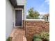 Front entry with dark gray door and brick wall at 4108 Solamor St, Lakeland, FL 33810