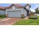 Gray house with tile roof and brick walkway at 4108 Solamor St, Lakeland, FL 33810